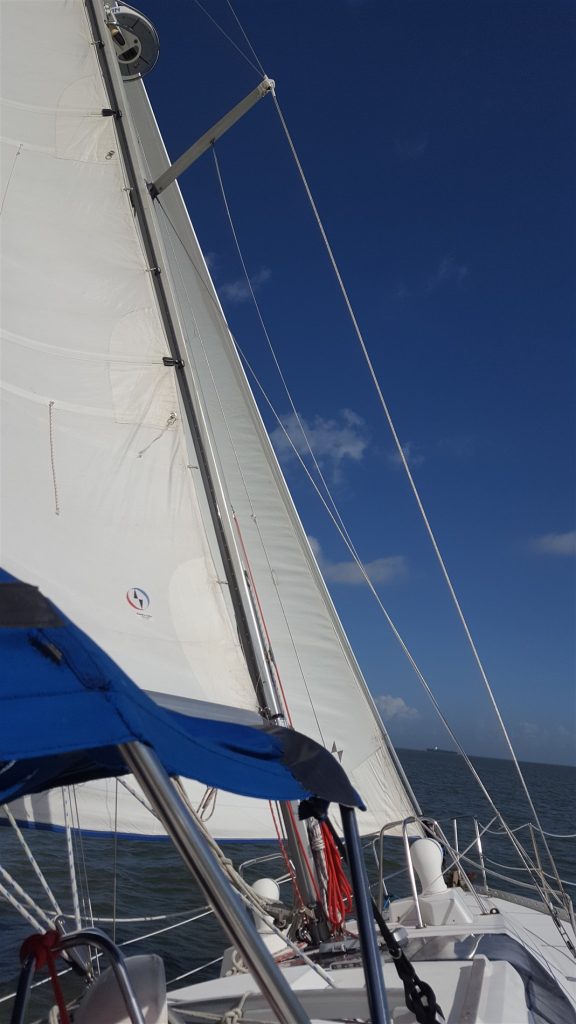 sailboat on the water with sails out, heeled over