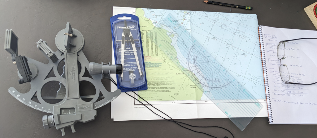 Image of a sextant, nautical chart, dividers, parallel plotter, pencil/eraser and notebook