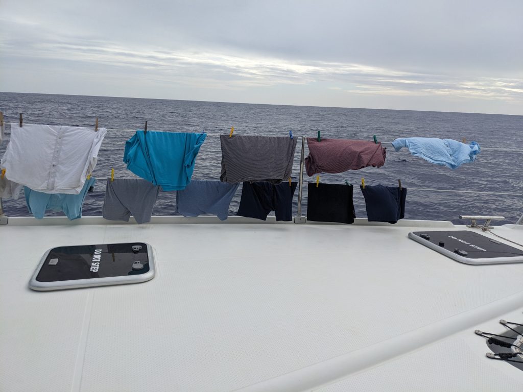 Image of clothes drying on the lifelines of a sailboat at sea