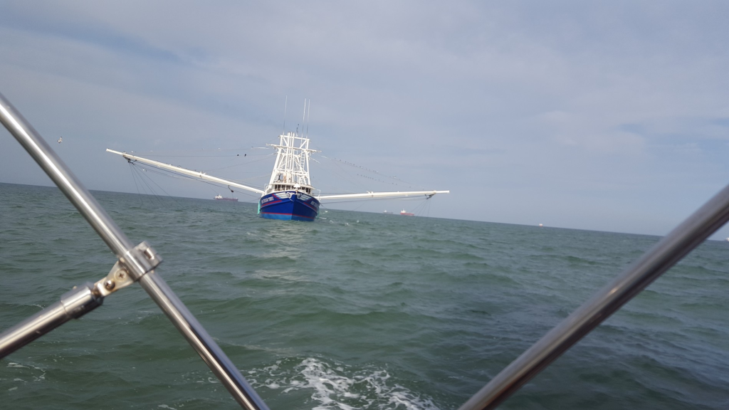 Image of a fishing boat with its nets out